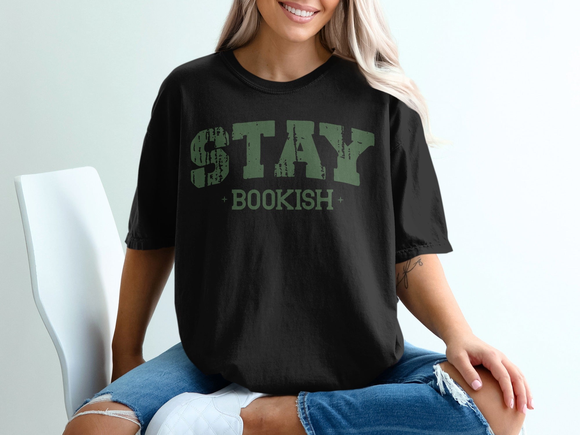 Black t-shirt with distressed green "STAY BOOKISH" graphic.