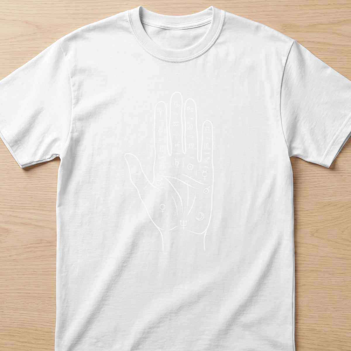 White t-shirt with a minimalist line drawing of a hand with astrological symbols.