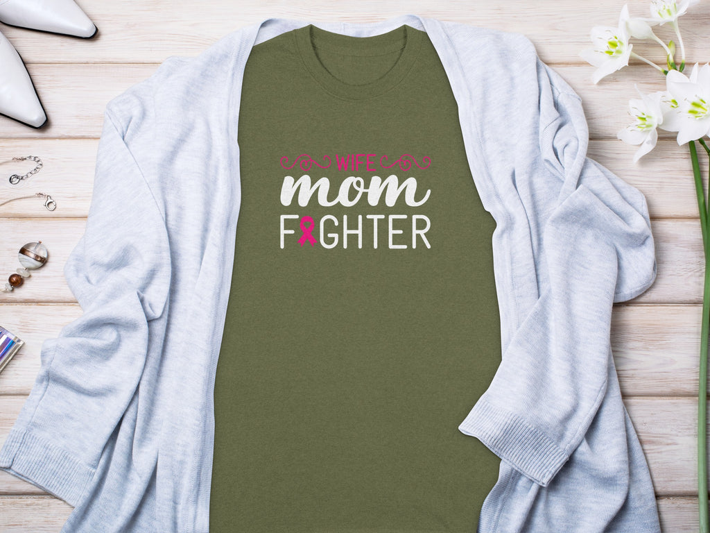 Olive green t-shirt with "Wife, Mom, Fighter" text and pink breast cancer ribbon.