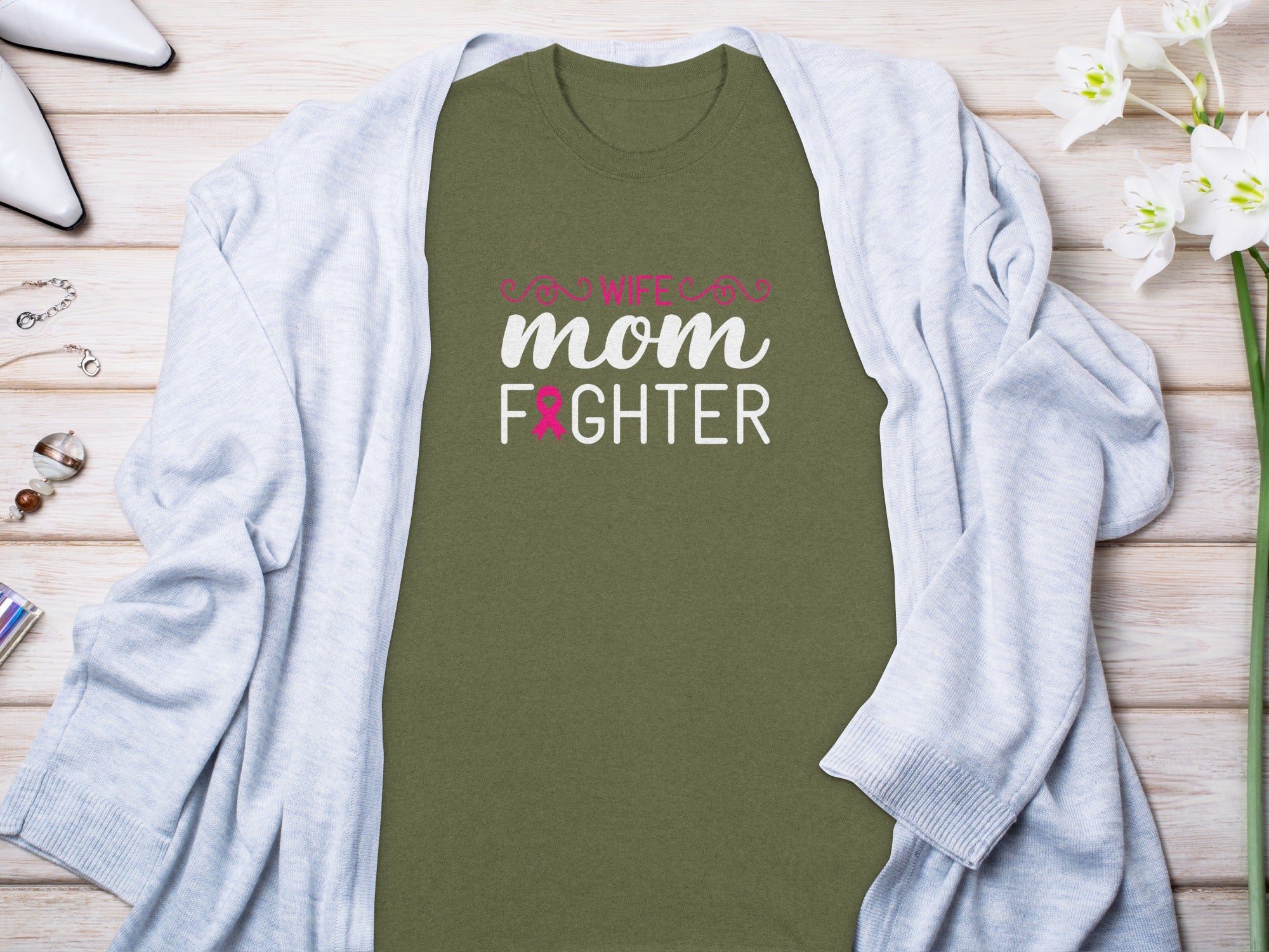Olive green t-shirt with "Wife, Mom, Fighter" text and pink breast cancer ribbon.