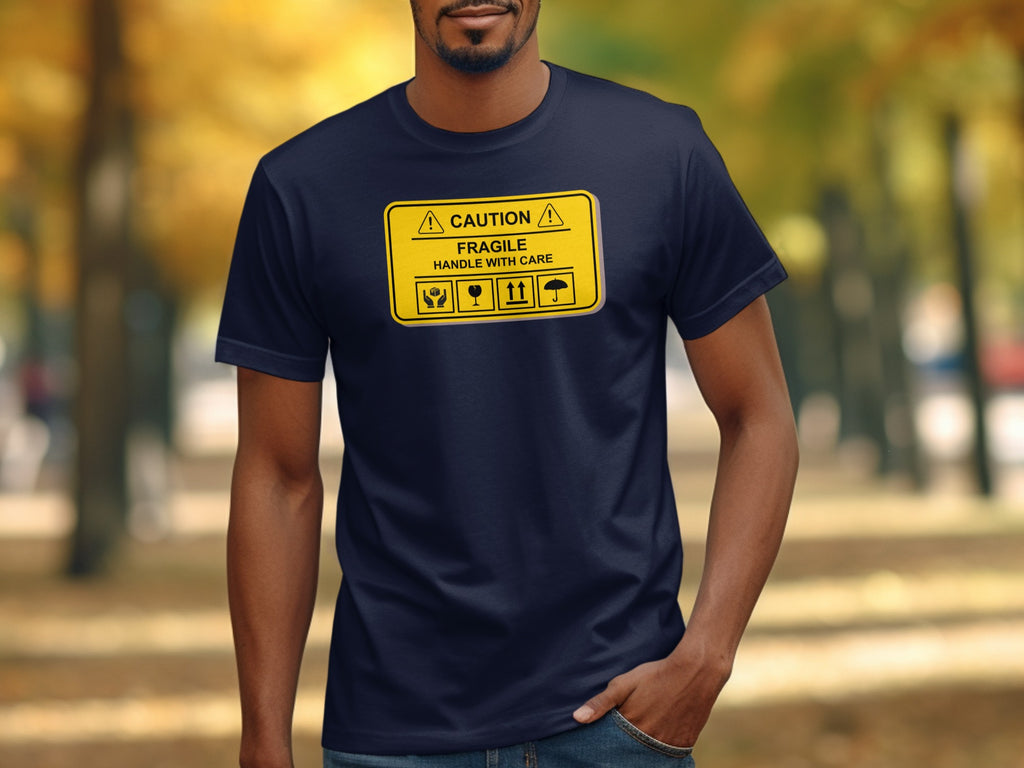 Man wearing navy t-shirt with yellow "Caution Fragile Handle with Care" graphic.