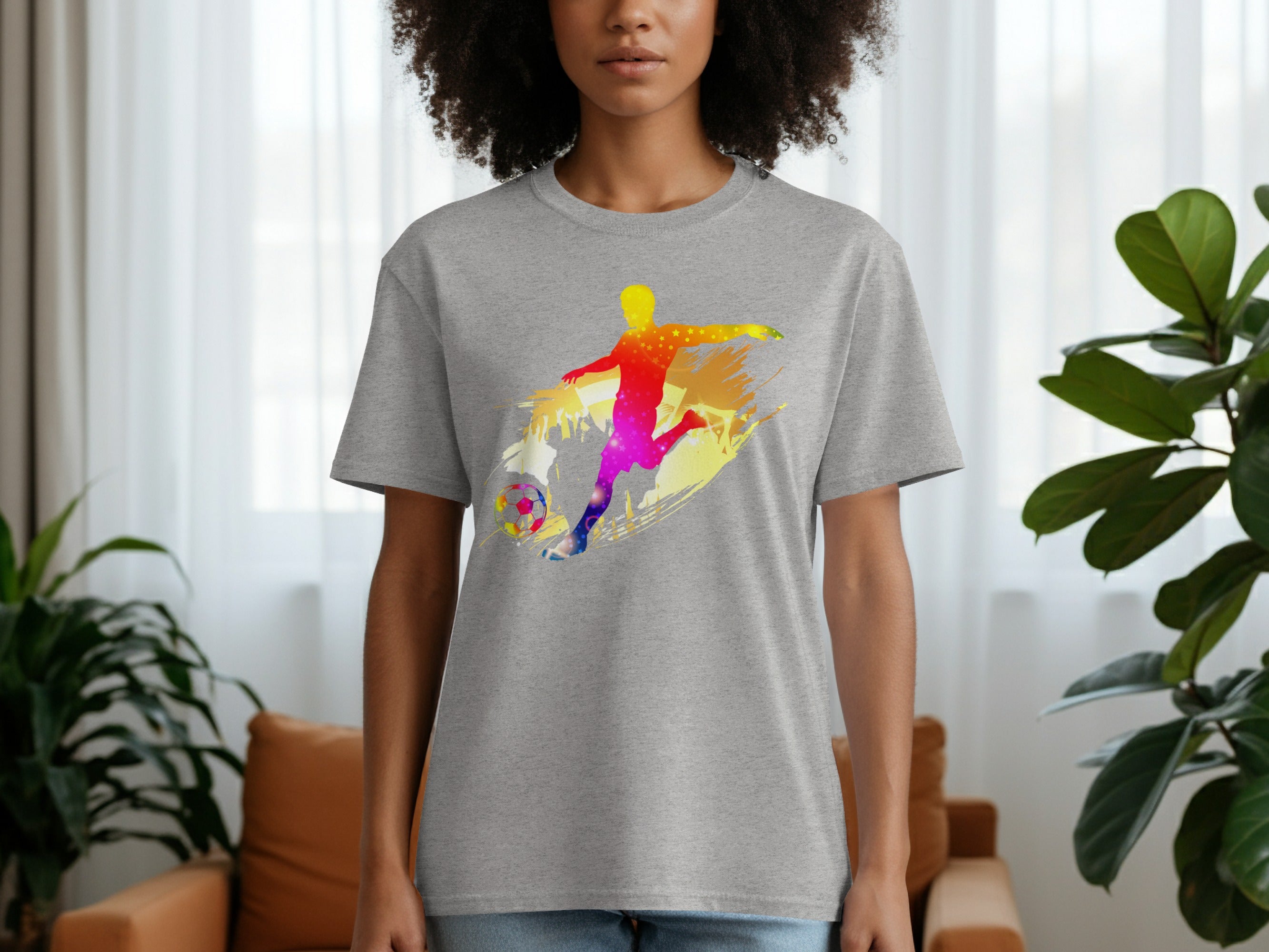 Grey t-shirt with a colorful watercolor soccer player graphic and ball design.