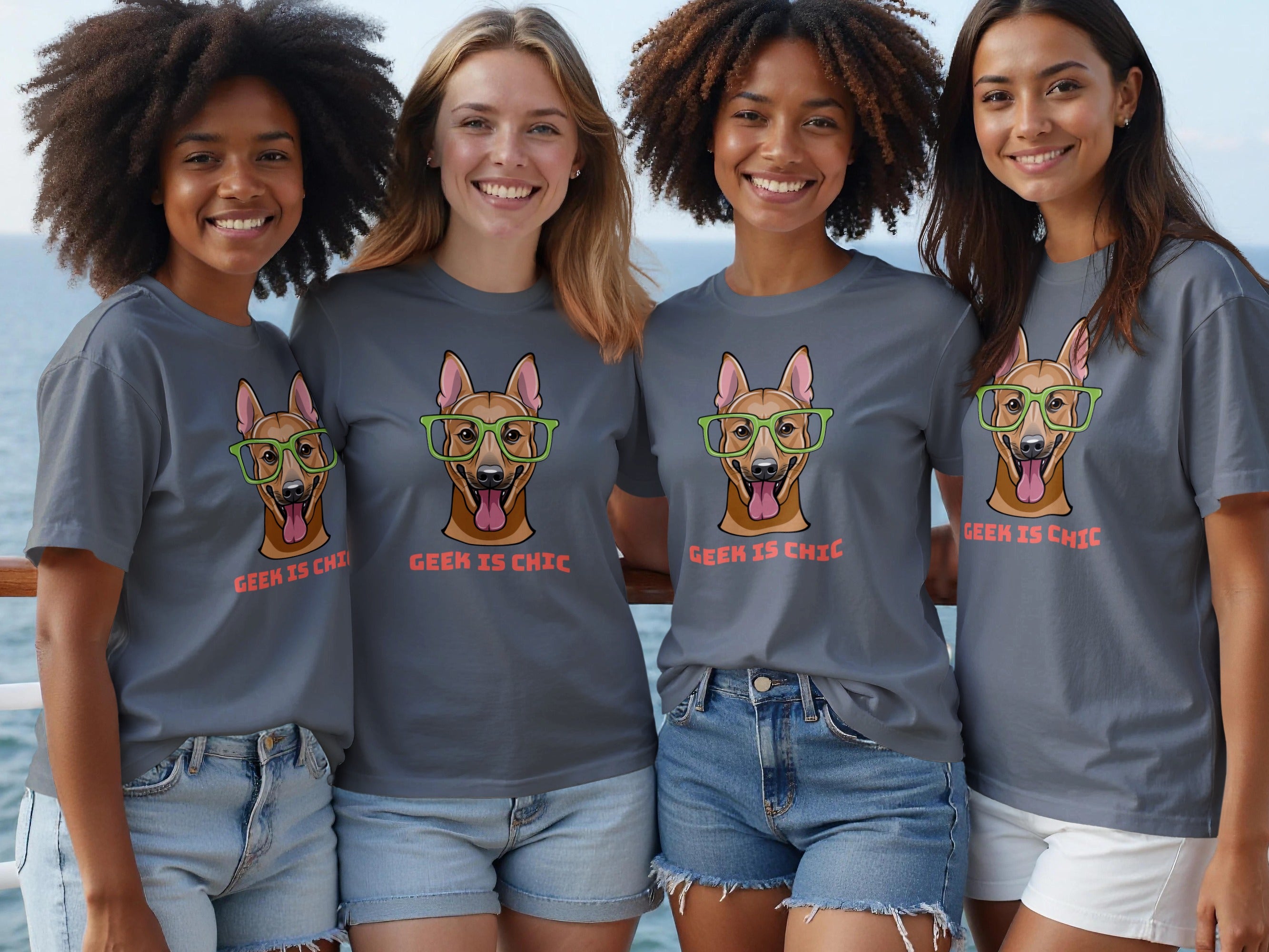 Four women wear grey t-shirts with a dog wearing glasses and text "GEEK IS CHIC".