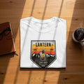 White t-shirt with "LANTERN" and camping graphic featuring a lantern.