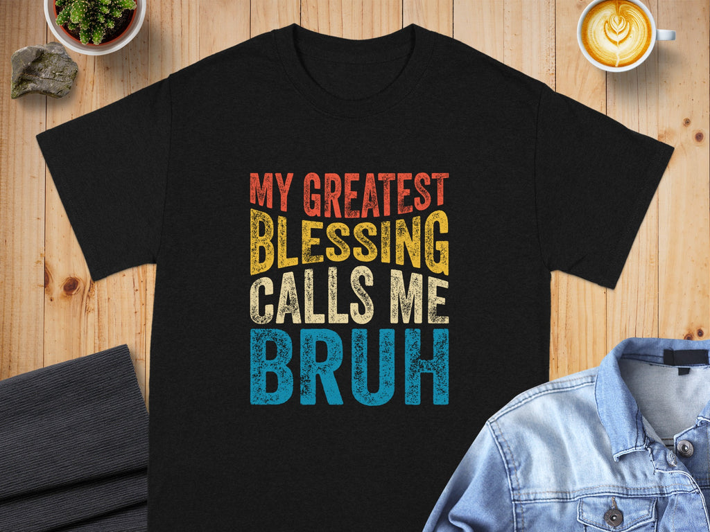 Black t-shirt with text: My Greatest Blessing Calls Me Bruh in distressed fonts.
