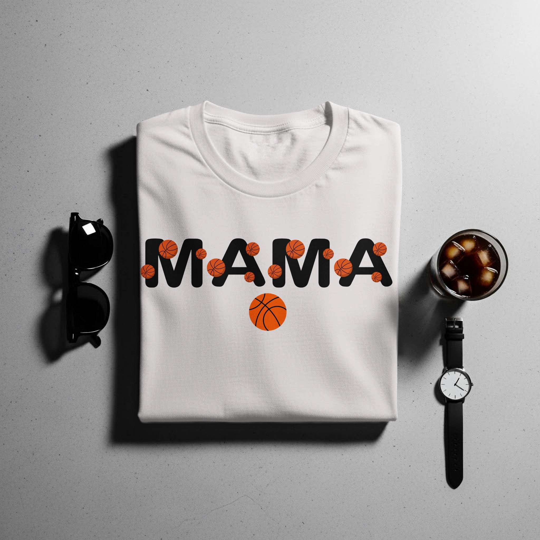 White t-shirt with black text "MAMA" and basketball graphics.