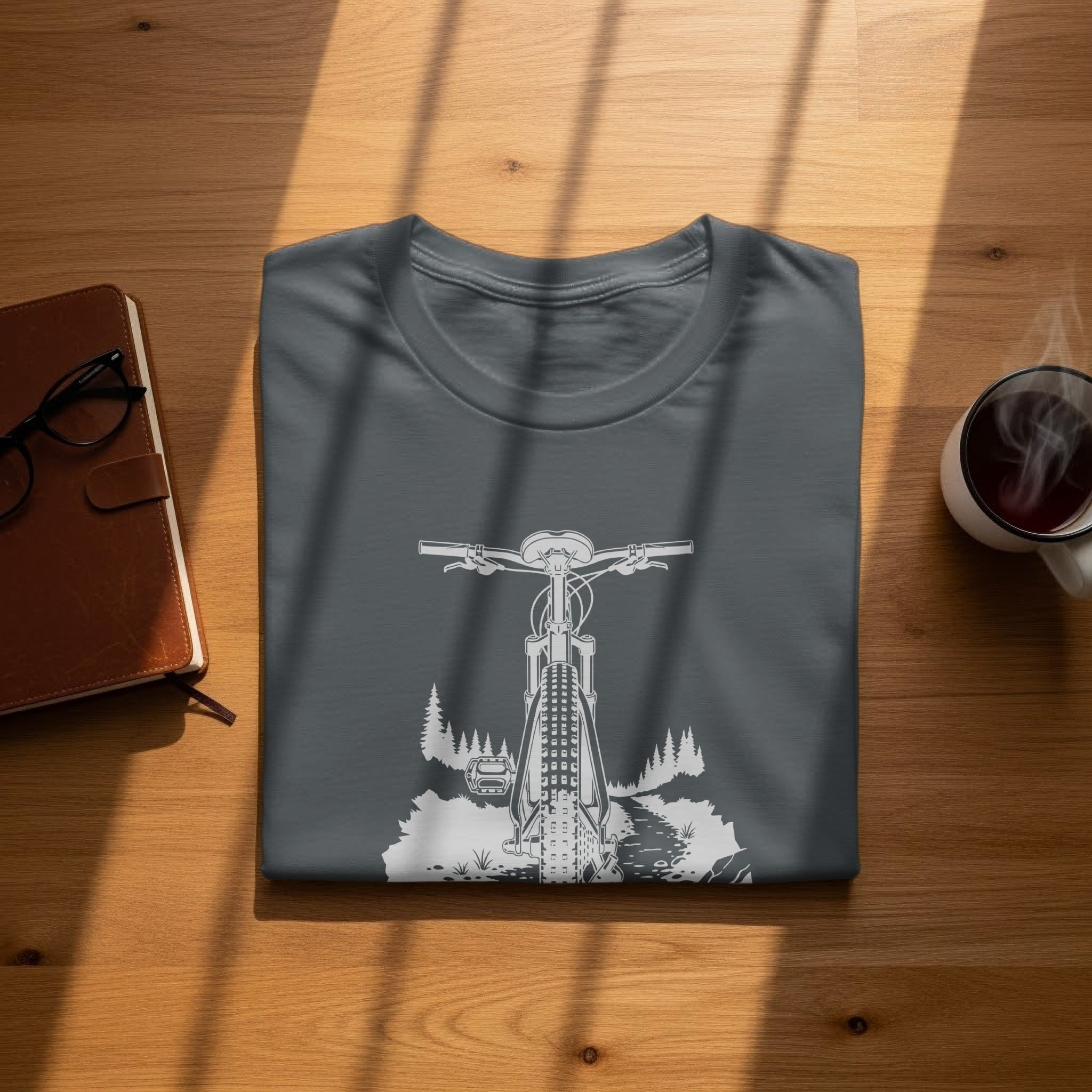 Dark grey t-shirt with a white graphic of a mountain bike on a trail.