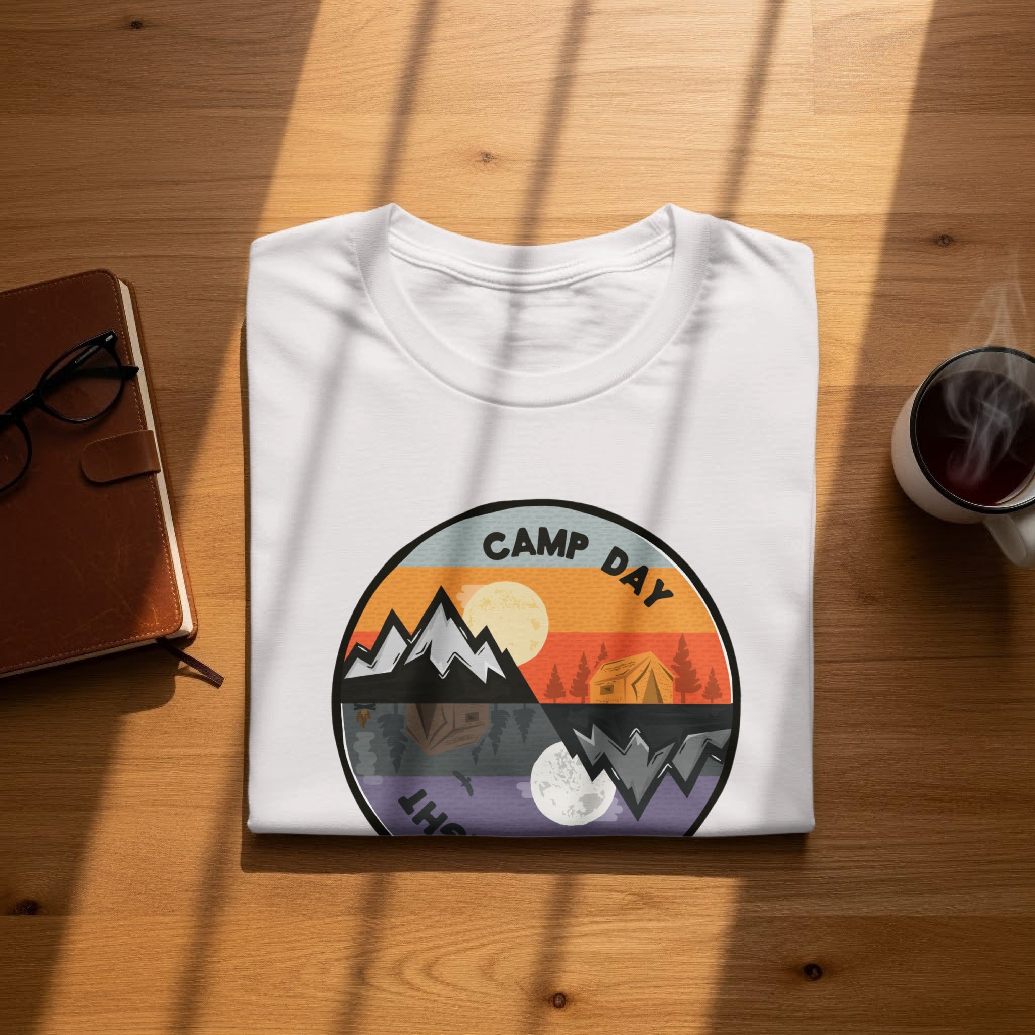 White t-shirt with circular graphic depicting day and night camping scenes.