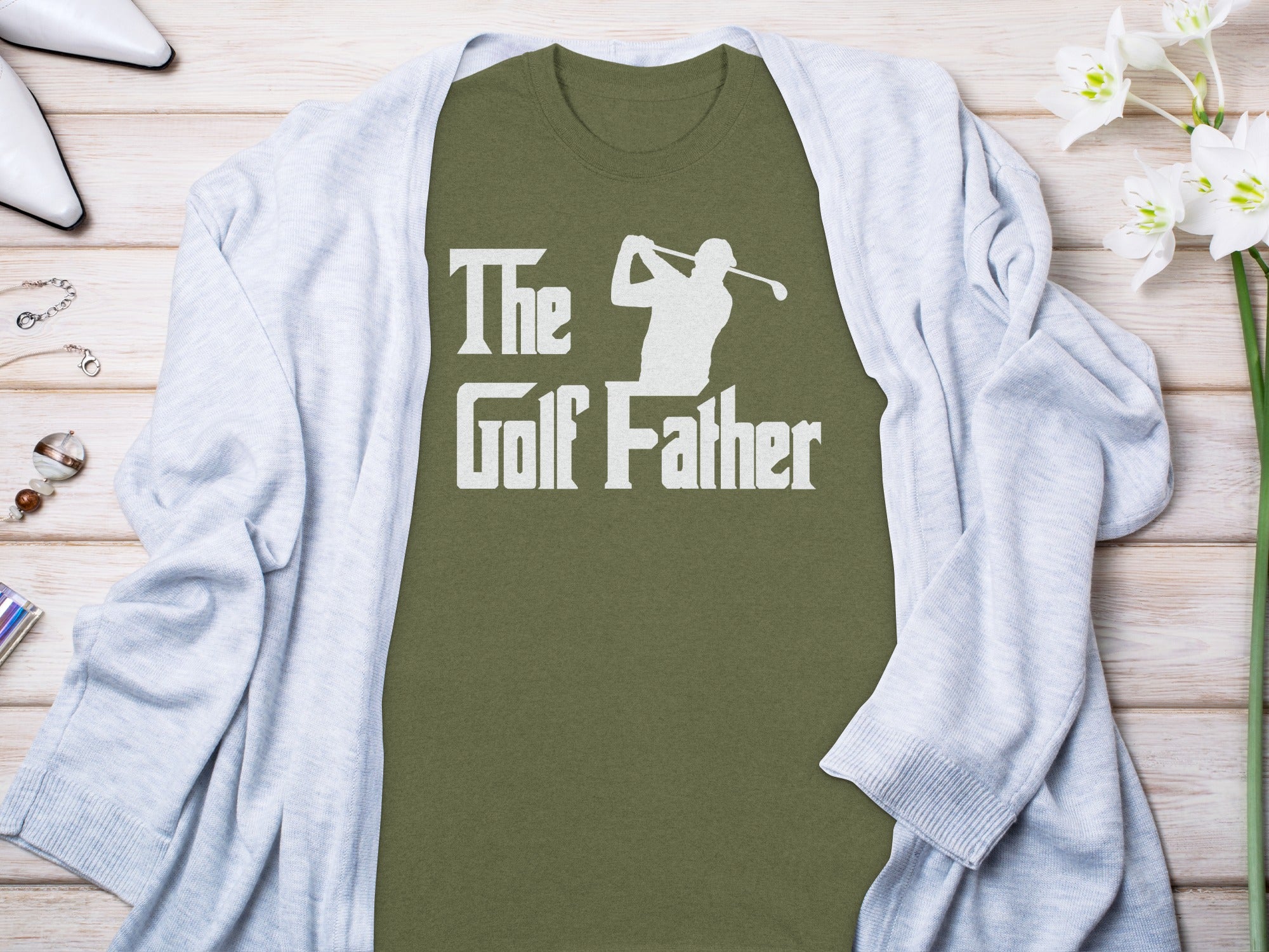 Green t-shirt with white text "The Golf Father" and golfer silhouette.