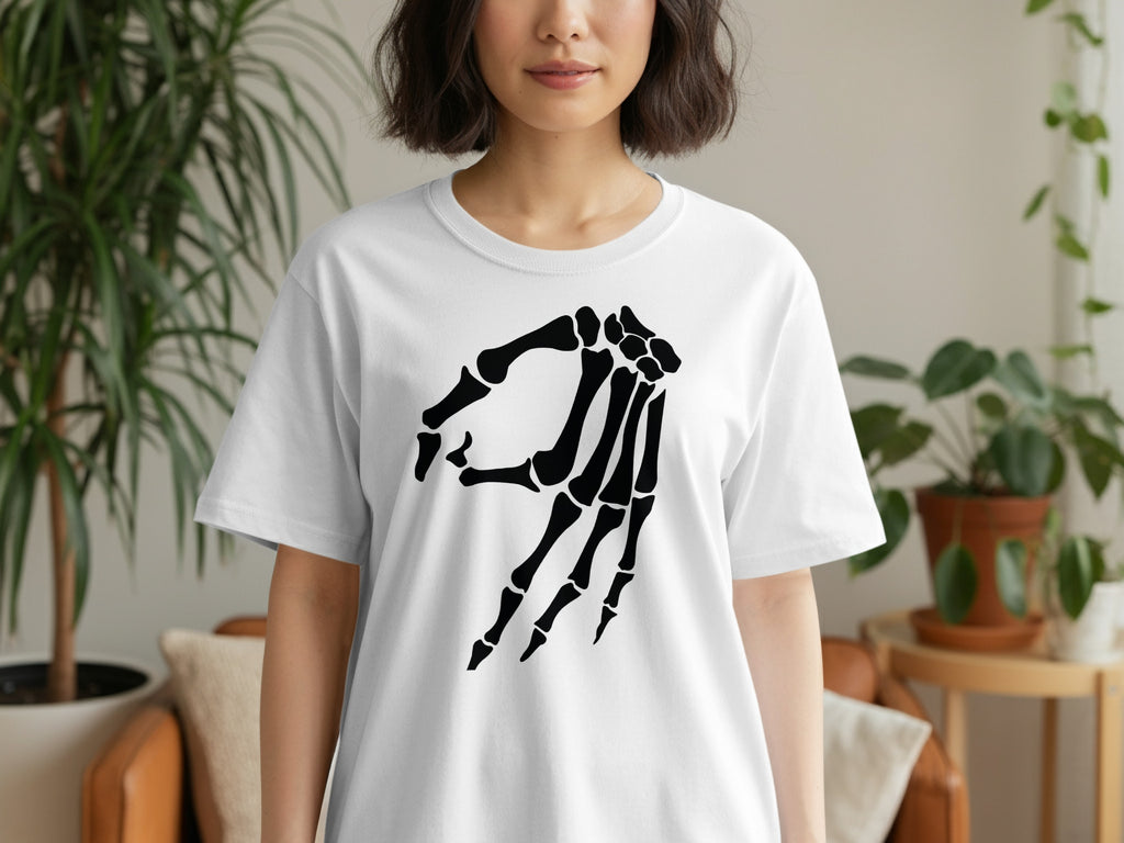 White t-shirt with a black skeleton hand graphic on the front.