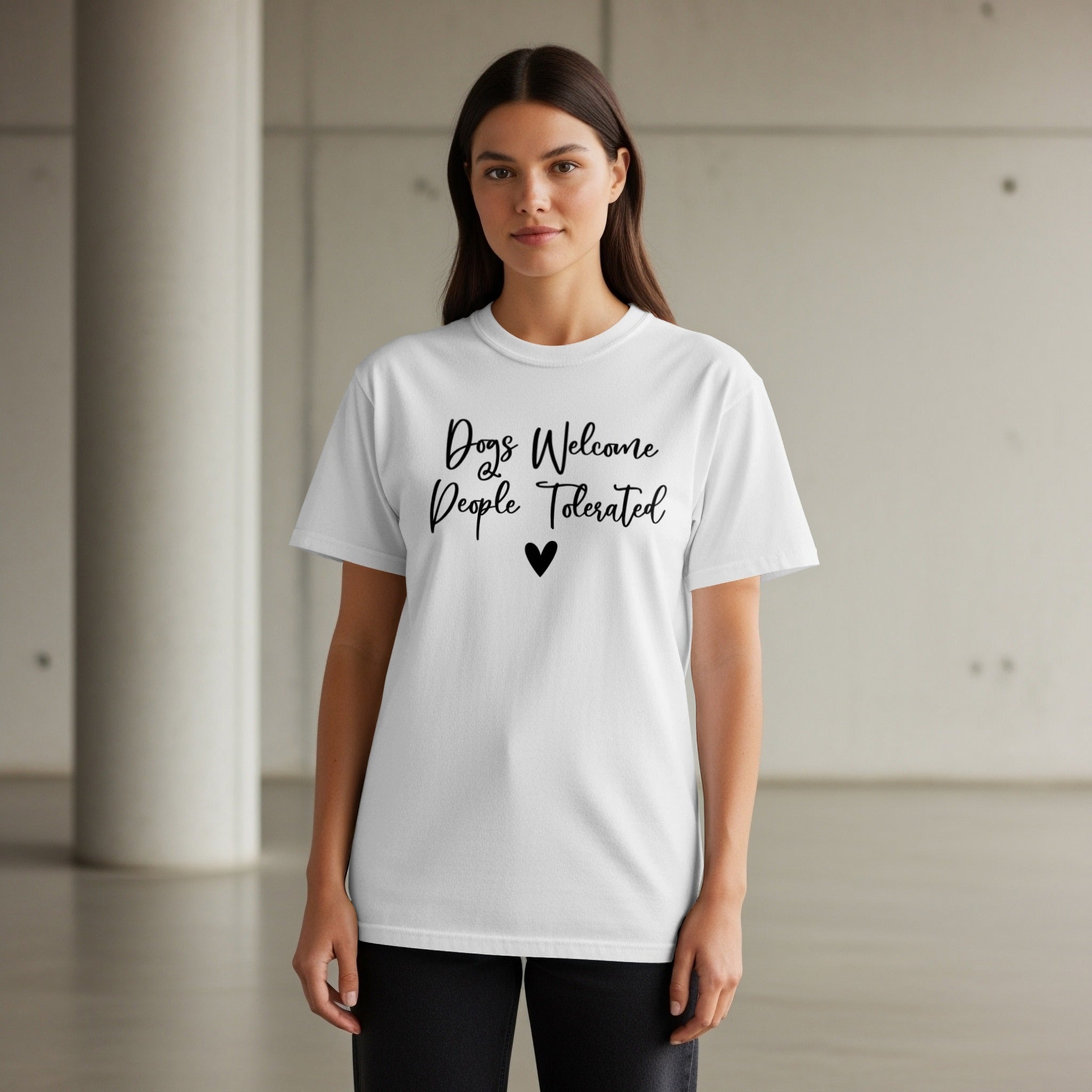 White t-shirt with black text "Dogs Welcome People Tolerated" and a small heart.