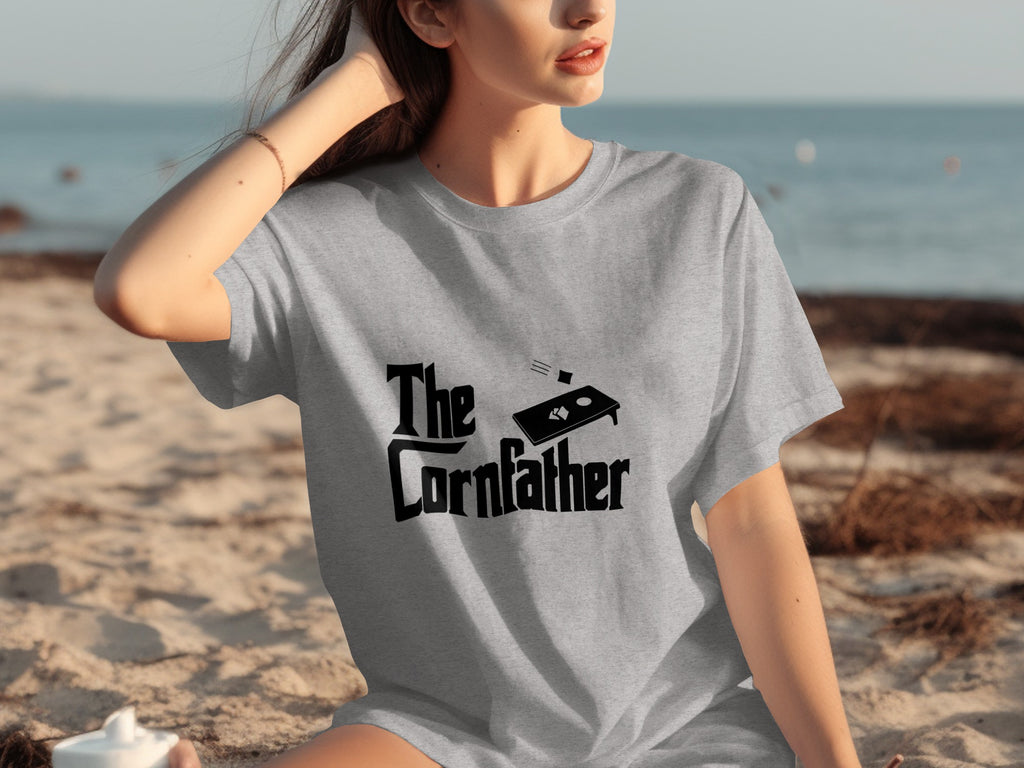 Grey t-shirt with "The Cornfather" text and a cornhole board graphic.