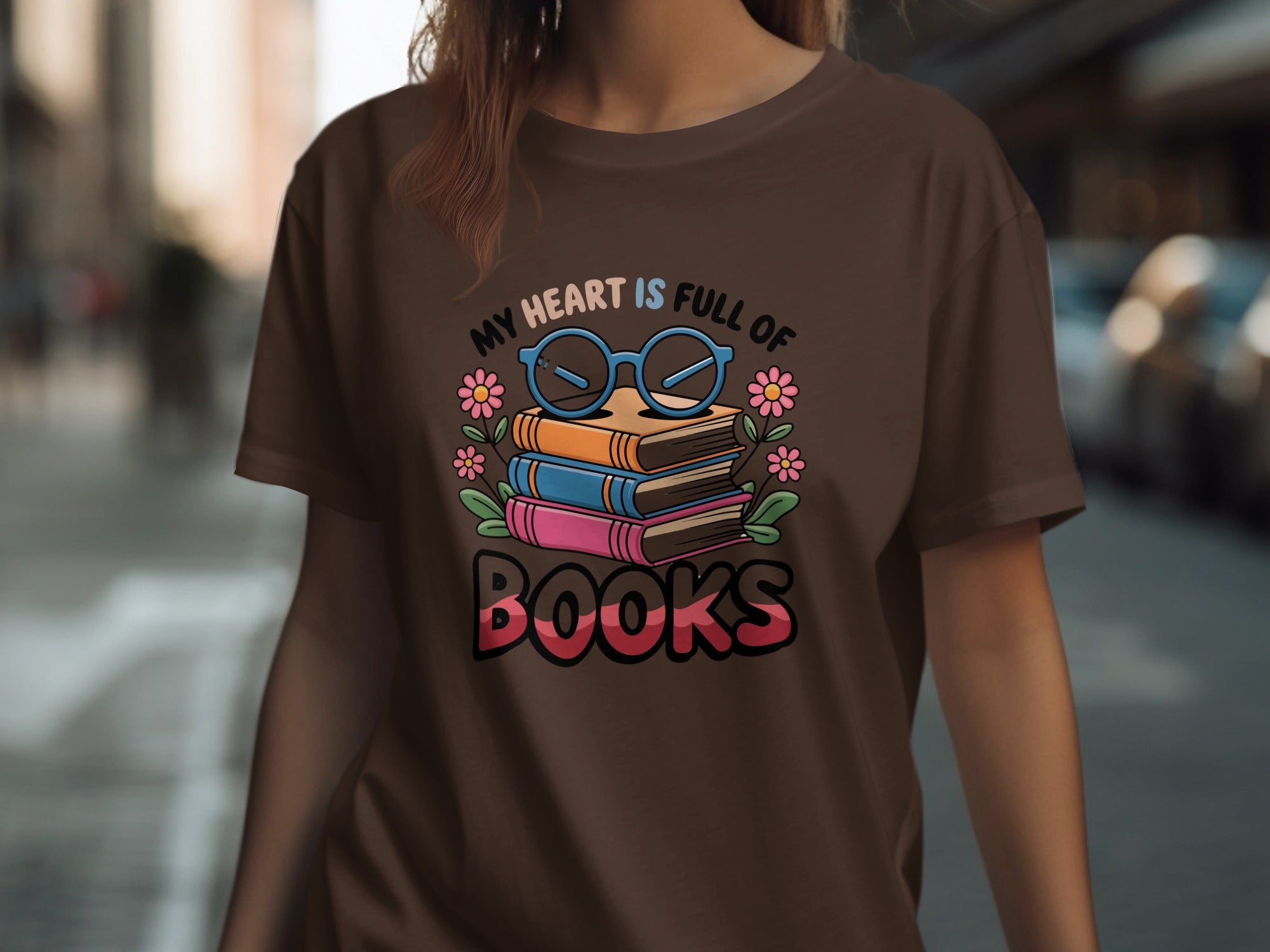 Brown t-shirt with graphic of stacked books, glasses, and flowers with text "My heart is full of books."