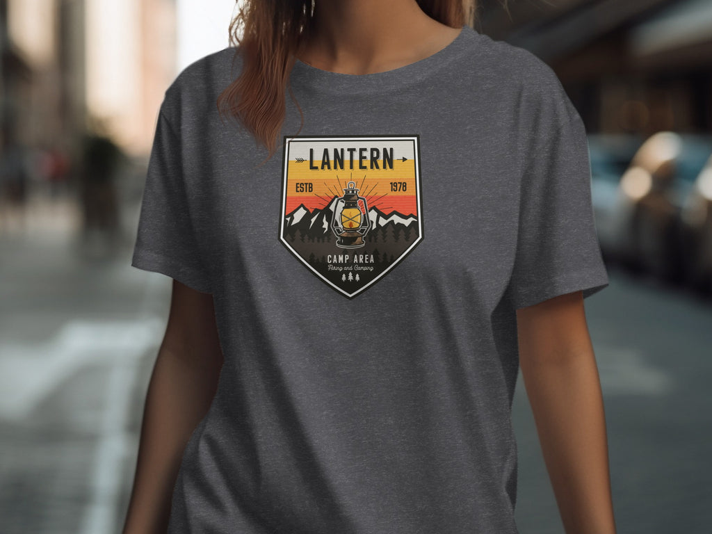 T-shirt with a crest featuring a lantern, mountains, and the text "Lantern Camp Area".