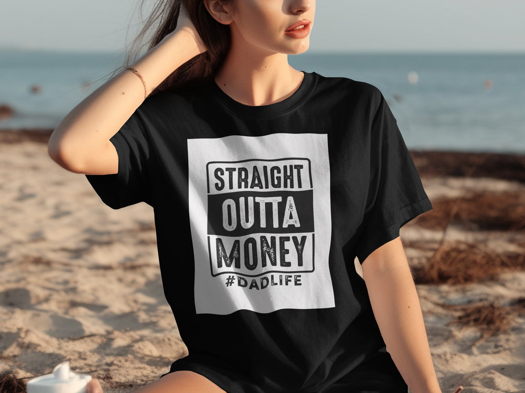 Black t-shirt with "STRAIGHT OUTTA MONEY #DADLIFE" text on a white rectangle.