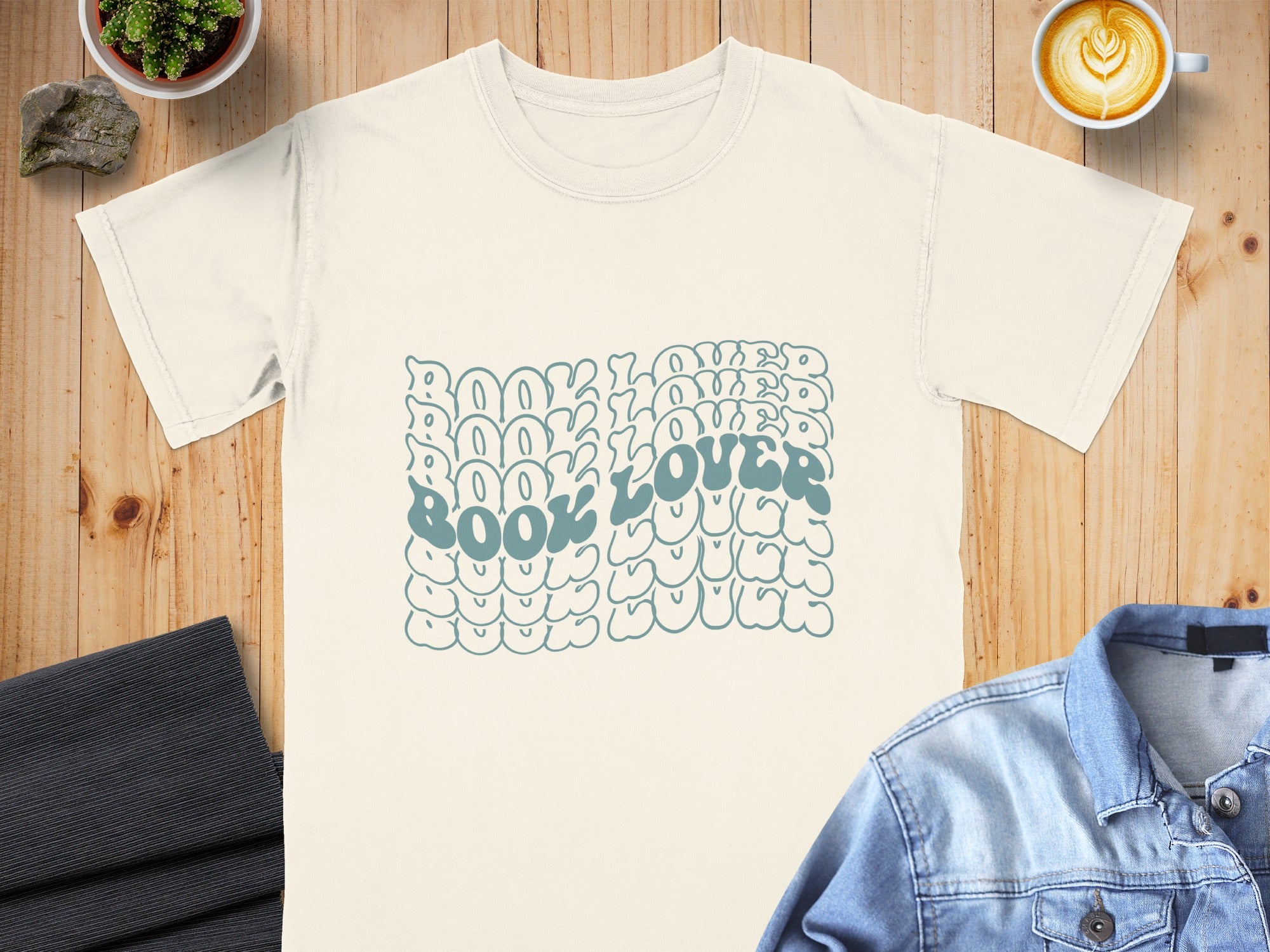 Cream t-shirt with blue retro "BOOK LOVER" graphic.