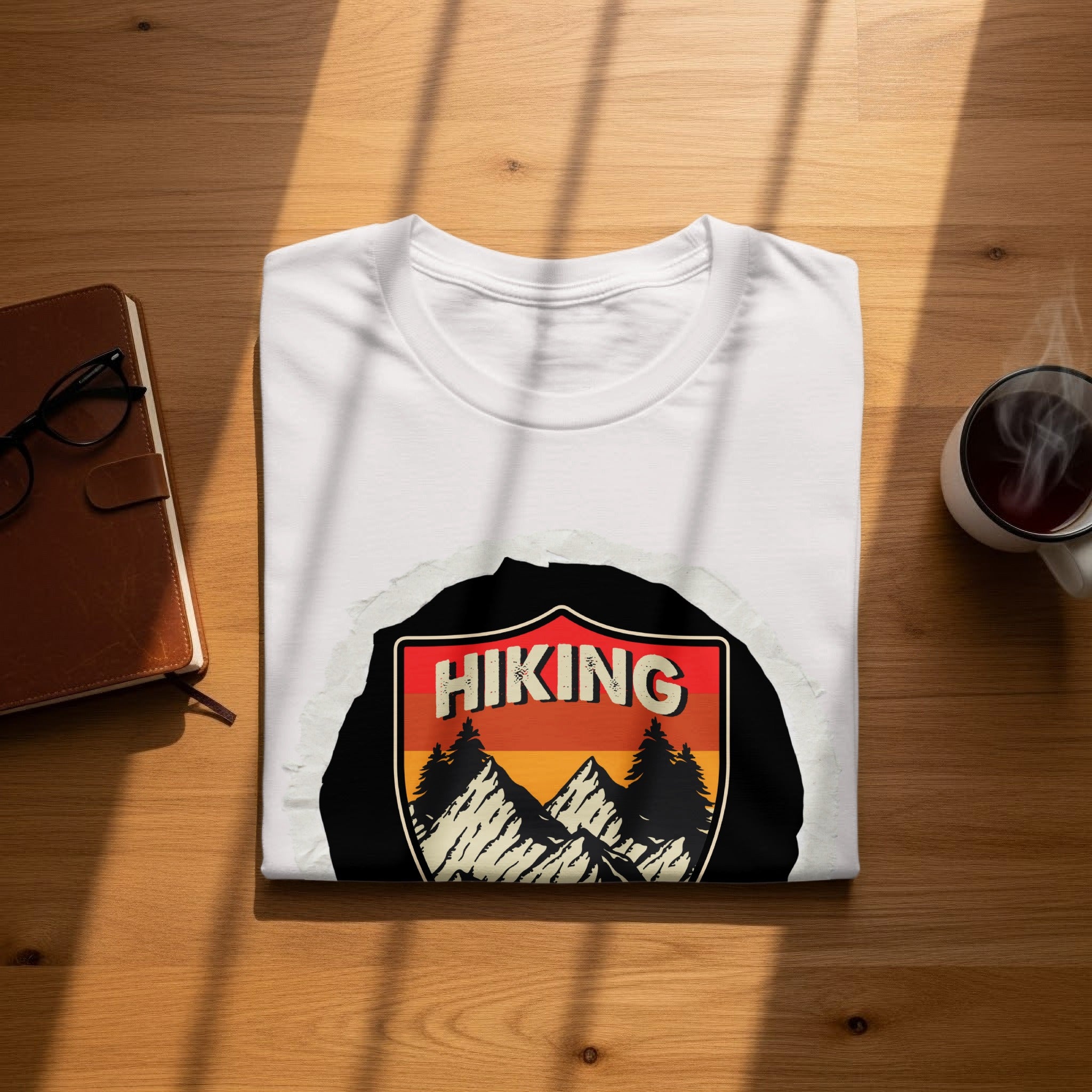 White t-shirt with vintage hiking mountain scene graphic and text.