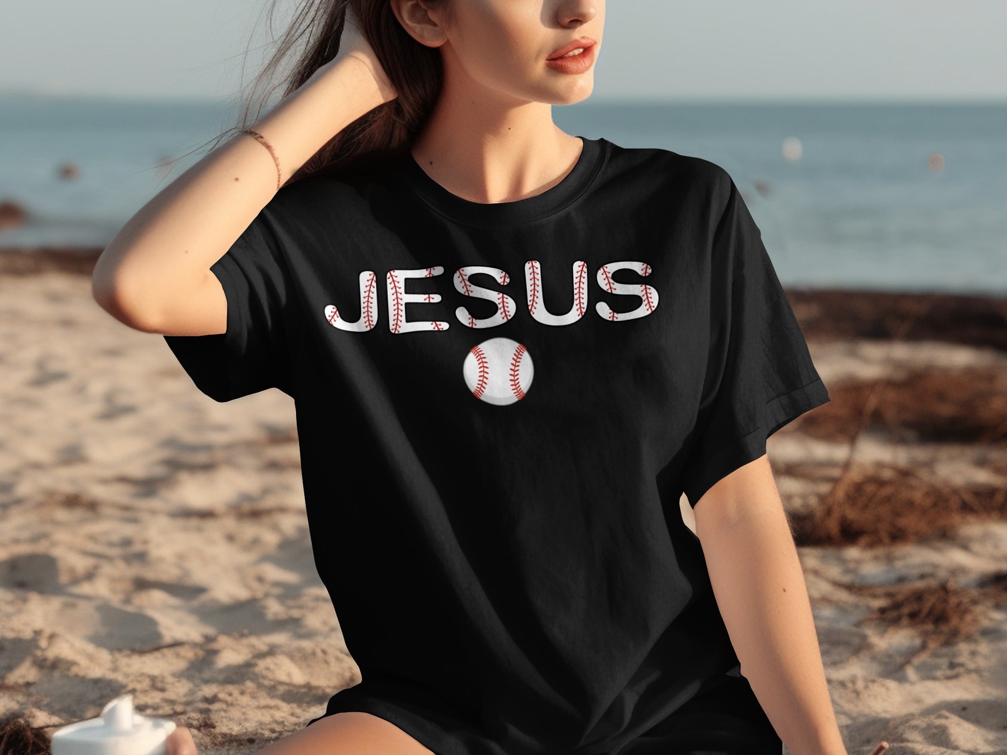 Black t-shirt with "JESUS" in baseball-stitch font and a baseball graphic.