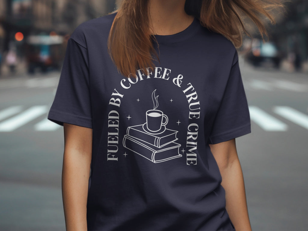 Navy t-shirt with "Fueled by Coffee & True Crime" text and a coffee cup on books graphic.