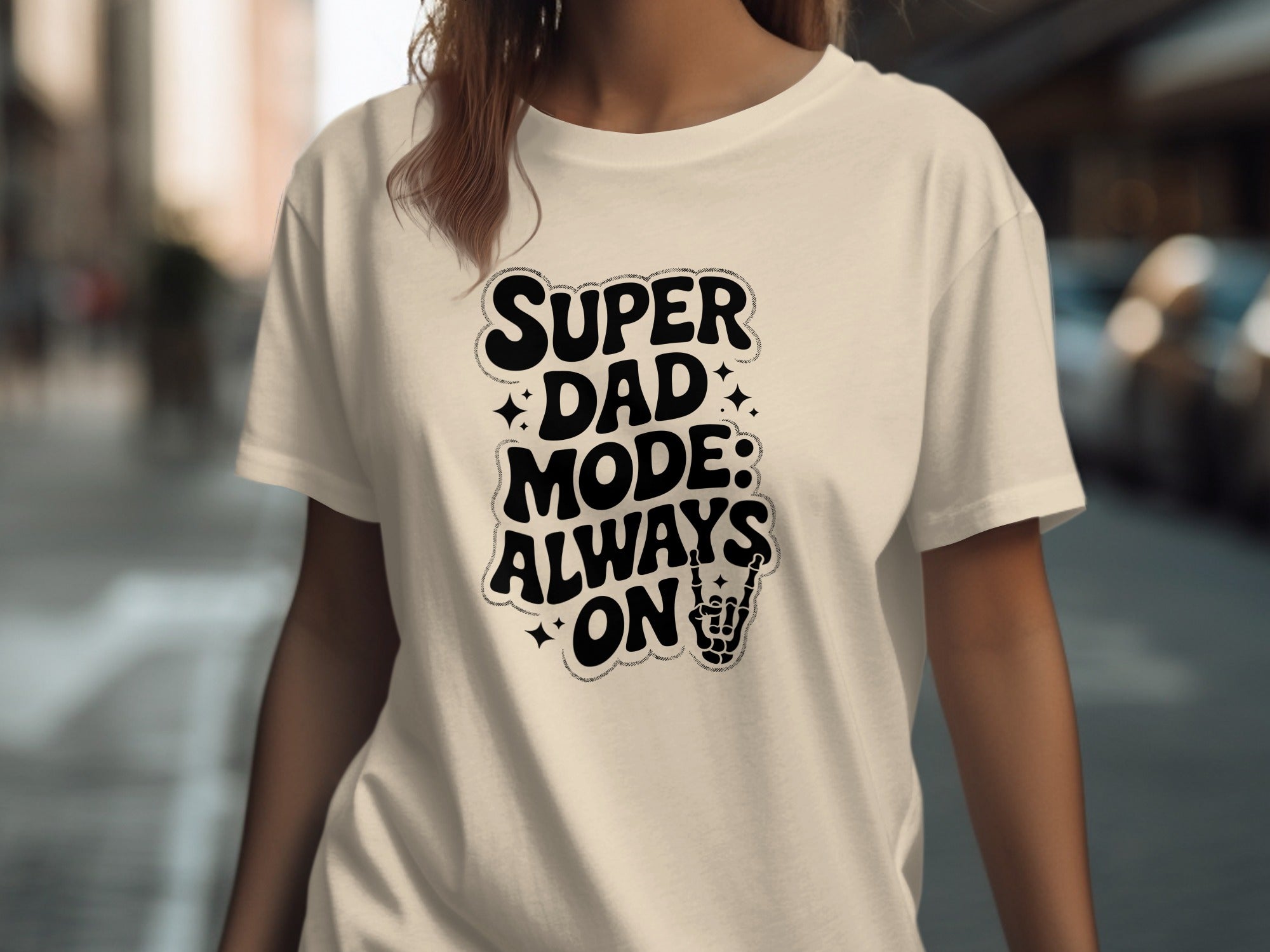 Cream t-shirt with black text "SUPER DAD MODE: ALWAYS ON" and a skeleton hand.