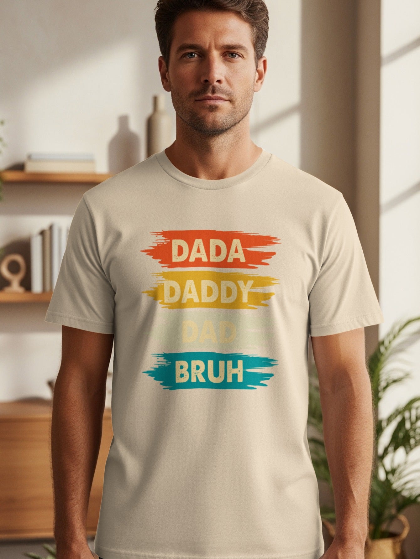 Light beige t-shirt with "DADA", "DADDY", and "BRUH" in colorful brush strokes.